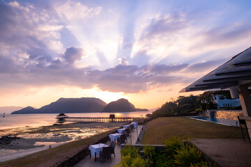 Langkawi, Malaysia: An outdoor dining scene at a resort hotel in beautiful island setting at sunset 