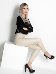 Fototapeta premium Beautiful blonde girl with long hair. Portrait in the studio