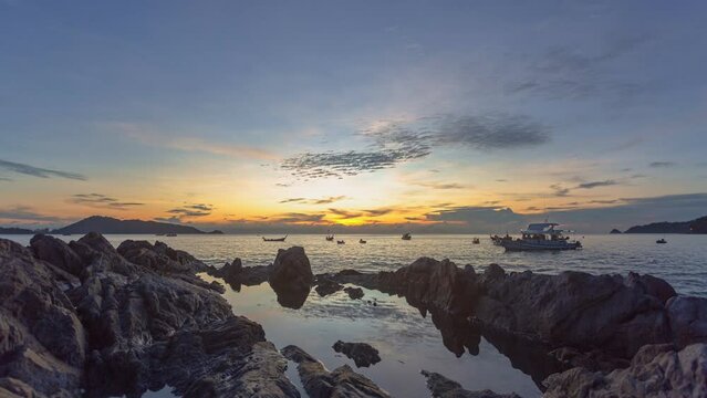 
time lapse reflection of sunset in water trapped in rocks.
beautiful sunset at Kalim beach fishing boats in the sea.
Kalim beach is conected to Patong beach there have a lot of reef and rocks
