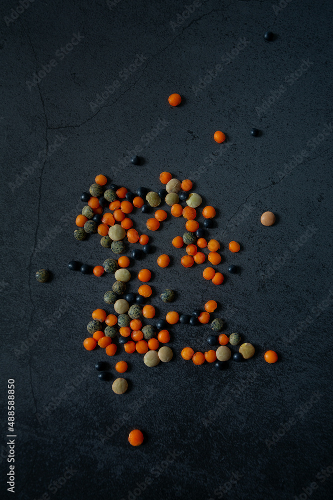 Poster lentil assortment on black stone surface