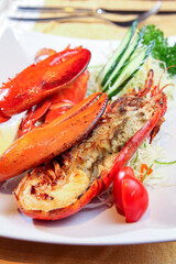 A plate of grilled lobster with salad