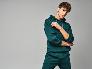Handsome man wear of green set of track suit isolated on gray background - obrazy, fototapety, plakaty