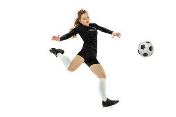 Leg kick. One sportive girl, female soccer player training with football ball isolated on white studio background. Sport, action, motion, fitness