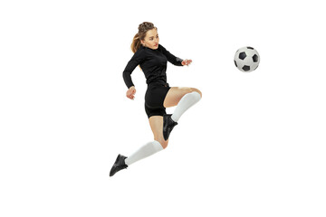 Attacking player. One sportive girl, female soccer player training with football ball isolated on...
