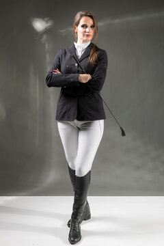 A woman in an equestrian outfit.  Riding outfit