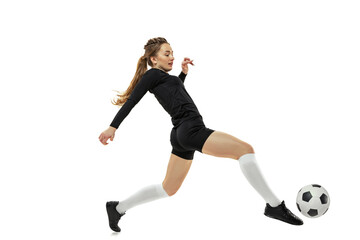 Workout. One sportive girl, female soccer player practicing with football ball isolated on white...