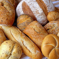 Freshly baked loaves of bread and crispy buns shot close-up