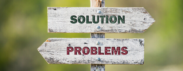 opposite signs on wooden signpost with the text quote solution problems engraved. Web banner format.