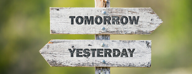 opposite signs on wooden signpost with the text quote tomorrow yesterday engraved. Web banner format. - obrazy, fototapety, plakaty