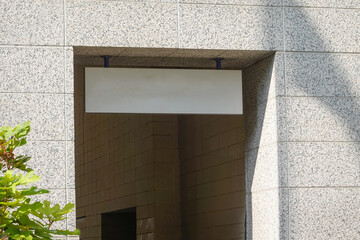 Blank sign over a stone doorway attached to the ceiling