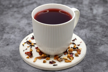 Apple Tea (Hibiscus tea) on dark background. Medicinal asian herbal tea. Fruit tea blended with Hibiscus, Rosehip, Orange Peel, Lemon Peel and Apple Flavor