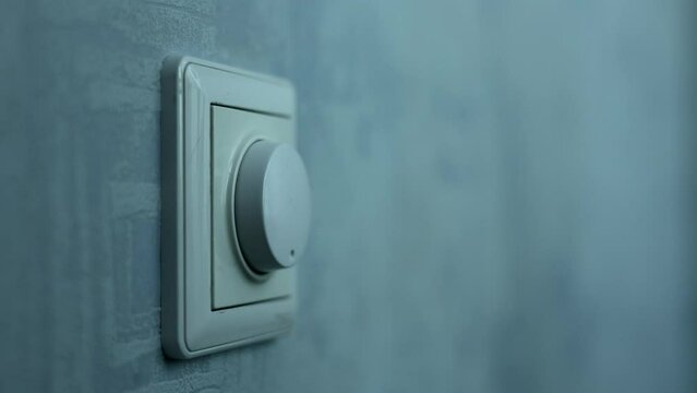 Male Hand Close-up Turns The Dimmer Switch Off The Light Switch