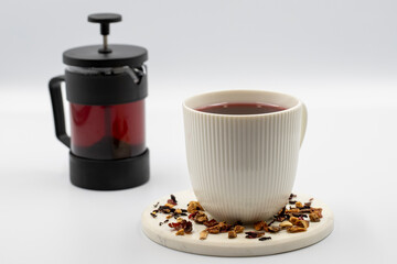 Apple Tea (Hibiscus tea) on a white background. Medicinal asian herbal tea. Fruit tea blended with Hibiscus, Rosehip, Orange Peel, Lemon Peel and Apple Flavor