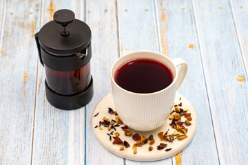 Apple Tea (Hibiscus tea) on a wooden background. Medicinal asian herbal tea. Fruit tea blended with Hibiscus, Rosehip, Orange Peel, Lemon Peel and Apple Flavor