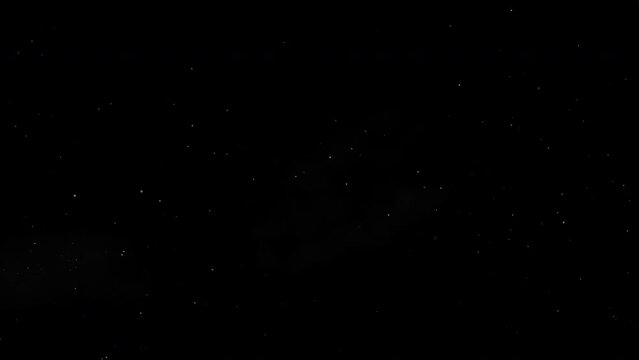 Floating particles on black background. Slow motion.
