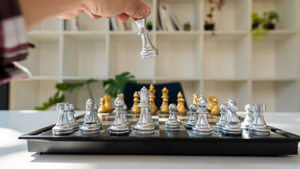 Strategy and planning concepts Close-up of a human hand making the first move in a game of chess kings. forward one field spot focus