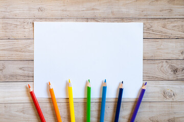 Obraz premium Colorful stationery set on the white background. Top view of blue, pink and purple notebooks, paper pins, eraser, felt tip pens, color pencils and watercolor. Back to school. Copy space.
