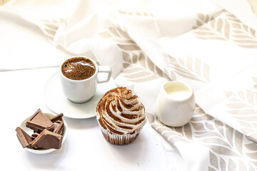 Dark chocolate and cocoa chocolate cupcakes with a cup of hot black coffee