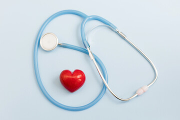 Stethoscope and red heart blue background