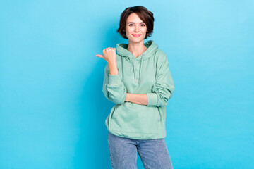 Photo of cool young bob hairdo lady index promo wear green pullover isolated on blue color...