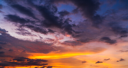 Colorful sunset sky in the evening with purple, orange sunlight clouds, dusk sky