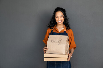 Satisfied small business owner holding delivery food box