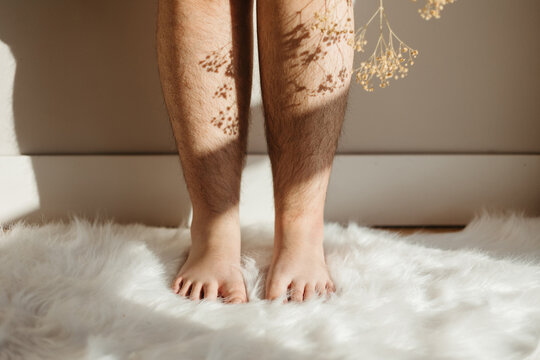 Unrecognizable barefoot woman with dried plants