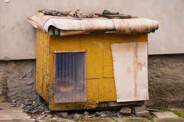 Homemade doghouse with transparent curtain.