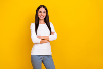 Photo of young cheerful woman crossed hands corporate economist isolated over yellow color background