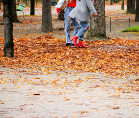 Paris. Autumn. Two trendy girls walking through a park in a hurry for shopping