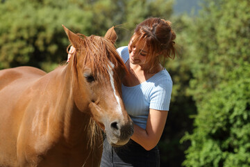 Happy woman petting a horse