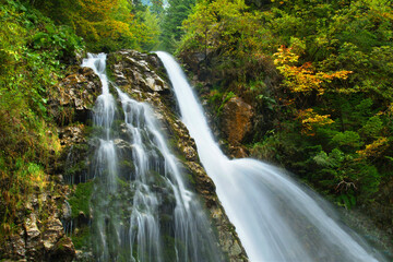 Fototapeta na wymiar Waterfall in the woods - Urlatoarea Waterfall Romania
