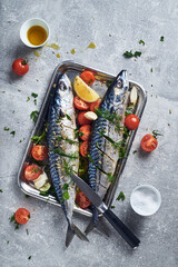 Mackerel fish prepared to cook in oven with spices tomatoes lemon and garlic. Mediterranean style to cook mackerel fish in oven.