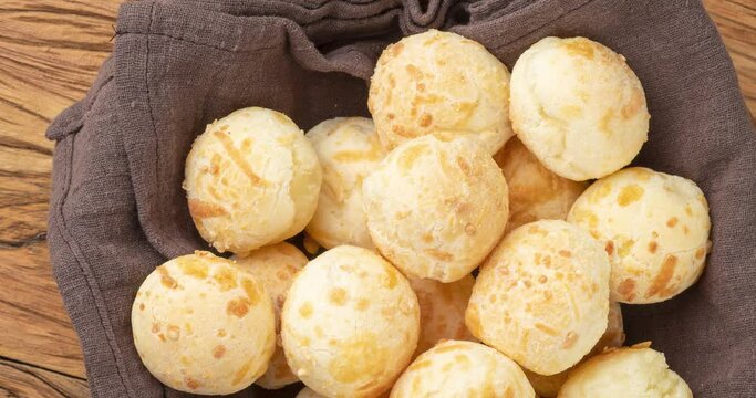 Typical brazilian cheese bun in a basket over wooden table