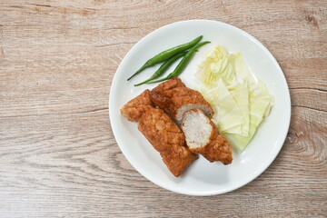 fried fermenting fish line eat with fresh cabbage and chili on plate