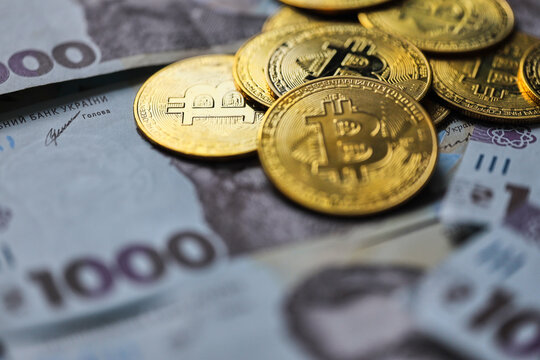 Ukrainian money with Cryptocurrency Coins.Bitcoin BTC, Ukrainian hryvnia, Tether USDT cryptocurrency physical coin