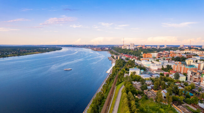 Aerial top view panorama city Perm and central embankment of Kama river Russia, sunset drone photo