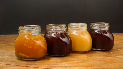 Home-made jam, selective focus. Jars with marmalade, confiture. Sweet dessert for toast, pie. Breakfast preparation.