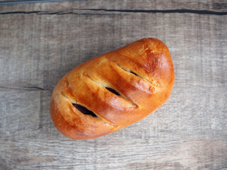 sausage in dough on wooden background