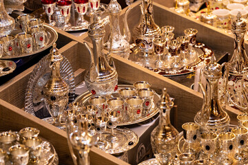 Fototapeta na wymiar Souvenir Gold Plated Traditional Arabic Tea Ernst Arab Style Bazaar at Dubai Old Souq, United Arab Emirates.