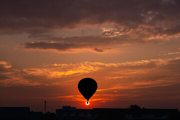 hot air balloons black silhouette rising up to the sky at sunrise