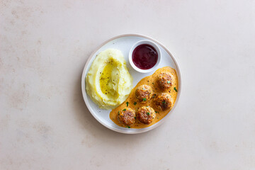 Swedish meatballs in cream sauce, potatoes and lingonberry sauce. Swedish cuisine. Recipe.