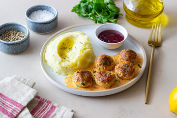 Swedish meatballs in cream sauce, potatoes and lingonberry sauce. Swedish cuisine. Recipe.
