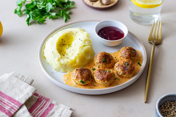 Swedish meatballs in cream sauce, potatoes and lingonberry sauce. Swedish cuisine. Recipe.