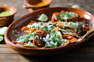 Mexican tacos al pastor accompanied by vegetables and sauces