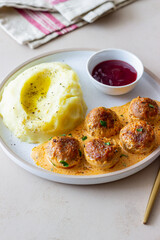 Swedish meatballs in cream sauce, potatoes and lingonberry sauce. Swedish cuisine. Recipe.