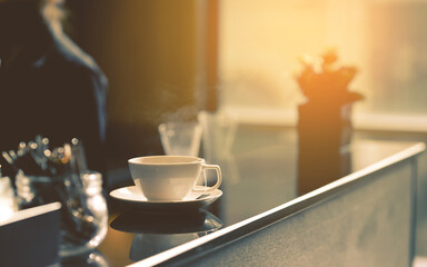 White cup of hot tea waiting for customer on counter bar in modern cafe coffee shop. Time of Tea Break.