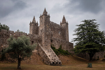 Fototapeta na wymiar Impressive defensive castle of Santa Maria da Feira, on a hill and under a cloudy sky
