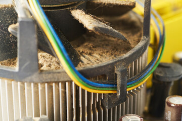 Old computer system unit with spiderweb and dust inside.