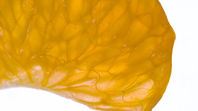 Сrushing Mandarin Fruits  in 5 Stories. Mandarin Fruits are compressed and crushed close-up on a bright white background, creating a juicy burst of pulp and a bright shell. Shooting at 120fps